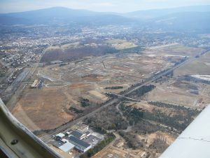 Everyone will be happy to see economic redevelopment begin at the Royal Phoenix Busi-ness Park portion of the former Avtex Superfund site. A preliminary drawing indicates the initial ITFederal building will go just west of (below) the EDA Headquarters in the old Ad-ministration Building at center left. The photo is looking east toward south-central Front Royal.