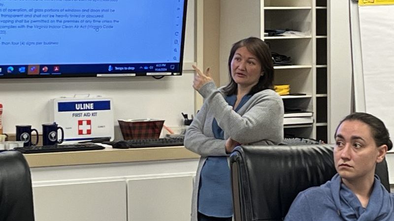 Planning Director and Zoning Administrator Lauren Kopishke assists the chair in moderating a discussion of the regulation of tobacco, smoke, or vape shops.